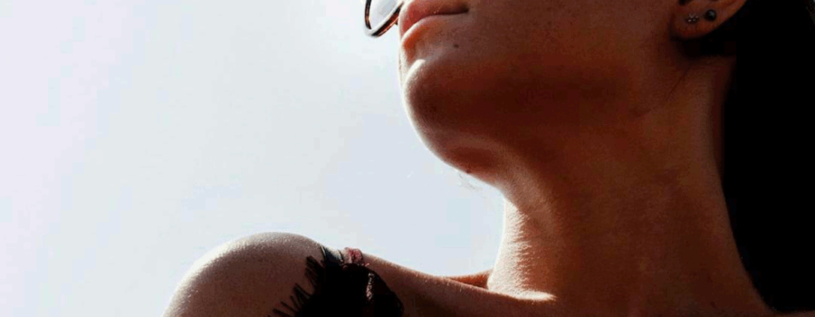 Partial view of a woman's head and right shoulder against the backdrop of the sky. This photo is used in www.becomingstoic.net in an article called "Benefits of Becoming Stoic".
