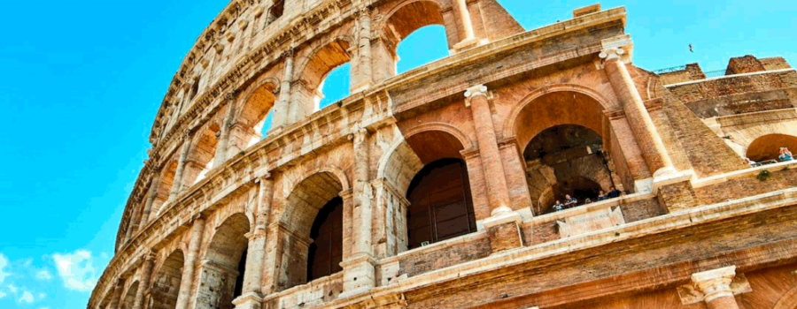 partial view of the Roman Colosseum with bright blue sky. Rome being the location of Marcus Aurelius, Seneca, and Epictetus, leading figures in this branch of philosophy. This photo is used on www.becomingstoic.net in a post called "Deep Dive into Stoicism".